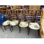 A SET OF FOUR ELM AND BEECH WINDSOR STYLE PIERCED SPLAT BACK DINING CHAIRS