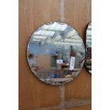 A FRAMELESS WALL MIRROR, 16" DIAMETER