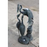 A METAL GARDEN FIGURE OF THREE HERONS