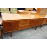 A RETRO TEAK SIDEBOARD WITH BRASS HANDLES ENCLOSING THREE DRAWERS AND THREE CUPBOARDS, 72" WIDE