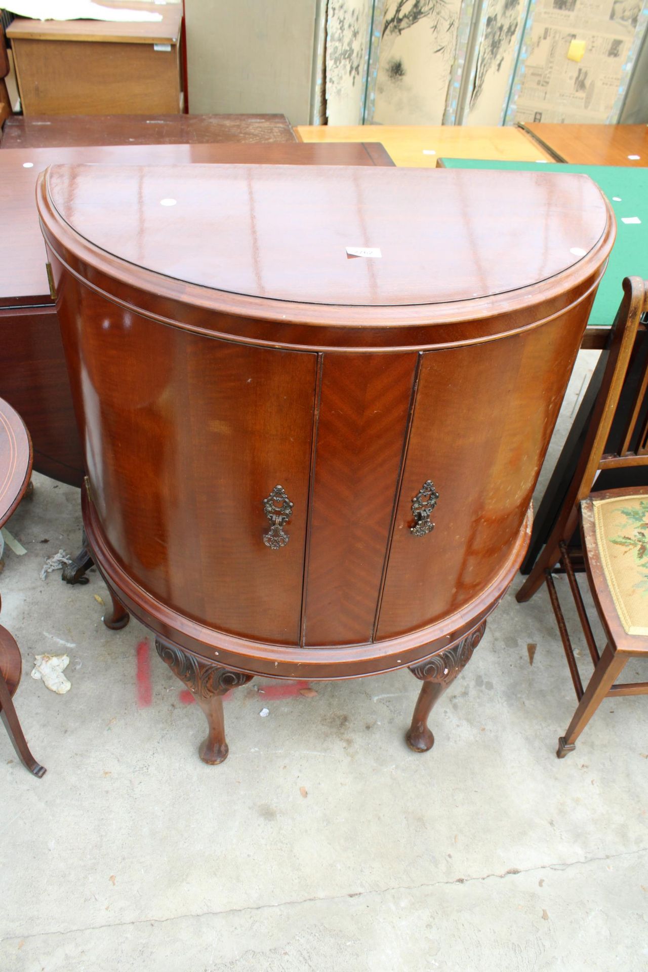 A MID 20TH CENTURY MAHOGANY BOW FRONTED TWO DOOR CABINET ON CABRIOLE LEGS 30" WIDE