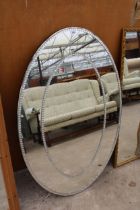 A MODERN OVAL MIRROR WITH TWO ROWS OF DIAMOND EFFECT DECORATIONS, 47" X 32"