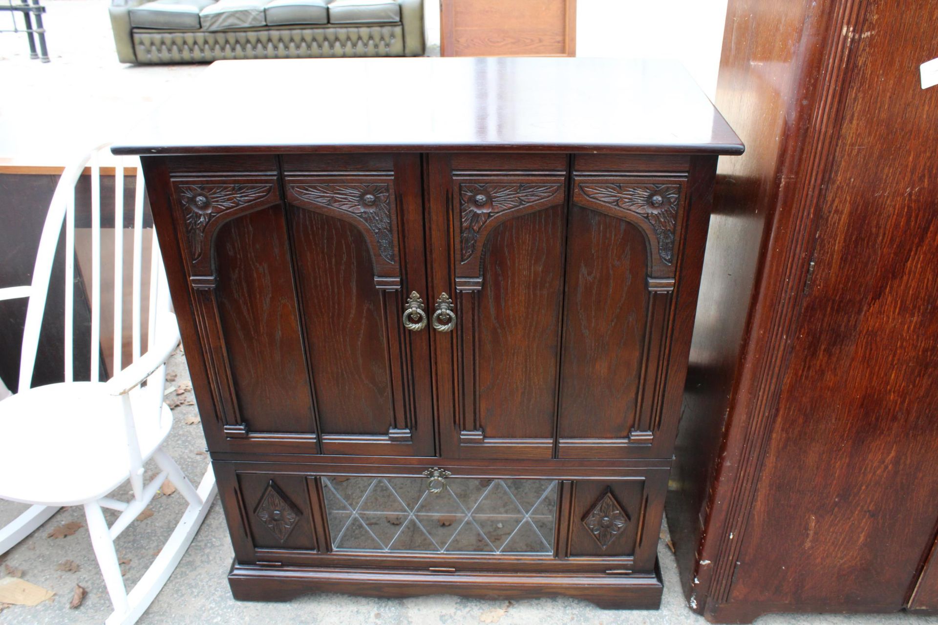 AN OAK ANTIQUE STYLE CABINET