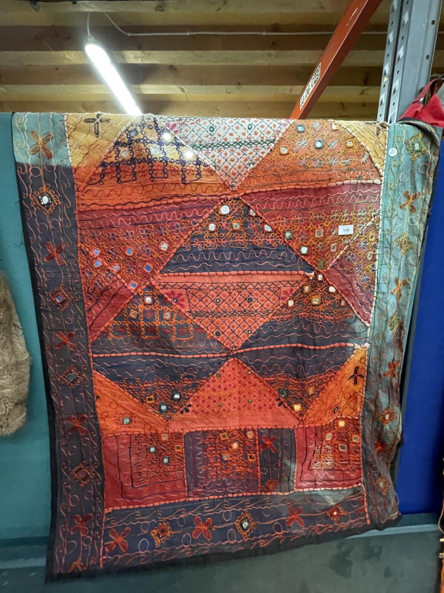 A RED AND TURQUOISE TAPESTRY, 98CM X 144CM