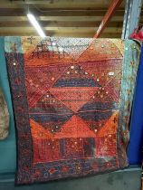 A RED AND TURQUOISE TAPESTRY, 98CM X 144CM
