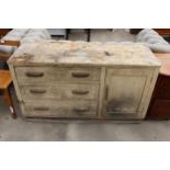 AN EARLY 20TH CENTURY BEECH BASE UNIT ENCLOSING THREE DRAWERS AND ONE CUPBOARD, 54.5" WIDE
