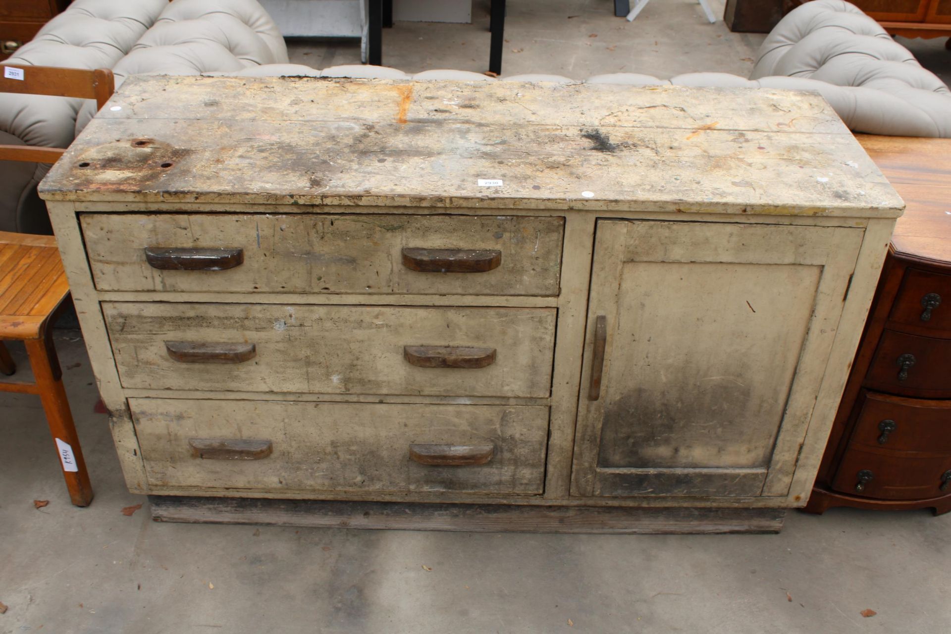 AN EARLY 20TH CENTURY BEECH BASE UNIT ENCLOSING THREE DRAWERS AND ONE CUPBOARD, 54.5" WIDE