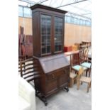 AN EARLY 20TH CENTURY OAK BUREAU BOOKCASE WITH GLAZED AND LEADED UPPER PORTION ENCLOSING CUTLERY