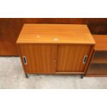 A RETRO TEAK STORAGE CUPBOARD WITH TWO SLIDING DOORS 35.5" WIDE