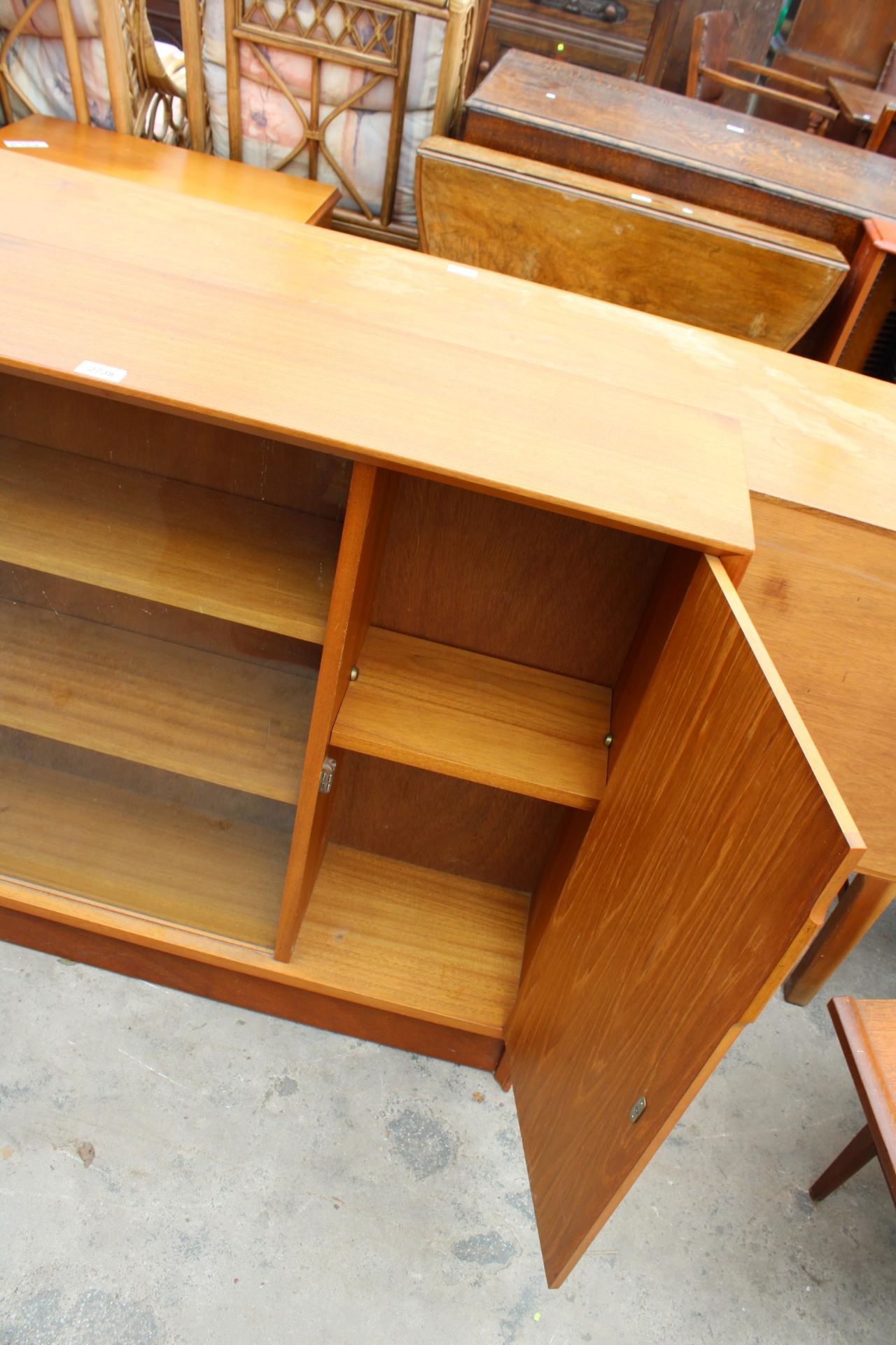 A RETRO TEAK GIBBS FURNITURE BOOKCASE ENCLOSING CUPBOARDS AND TWO GLASS SLIDING DOORS, 48" WIDE - Image 2 of 2