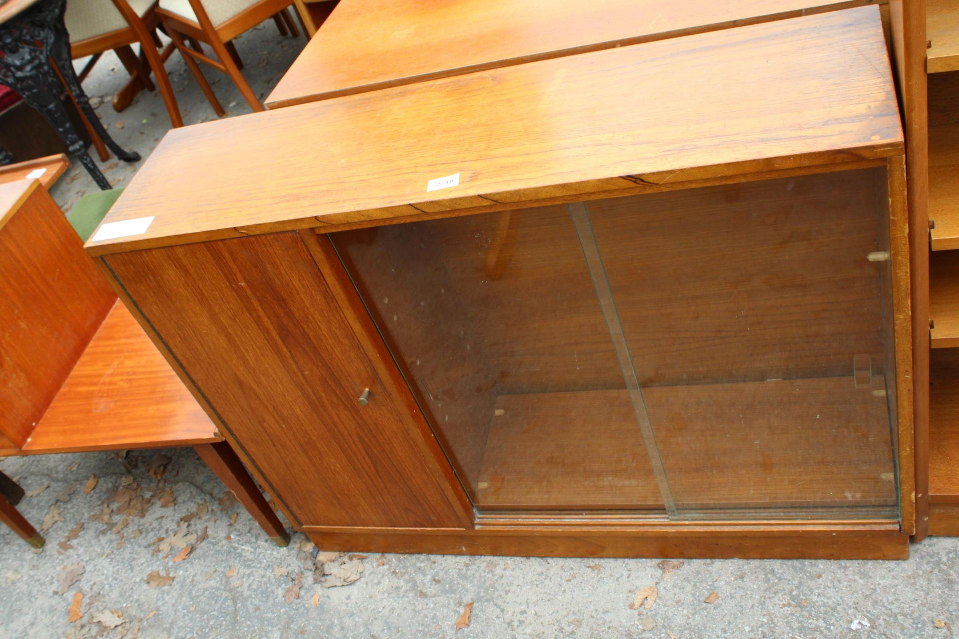 A RETRO TEAK BOOKCASE ENCLOSING CUPBOARD AND TWO GLASS SLIDING DOORS, 40" WIDE