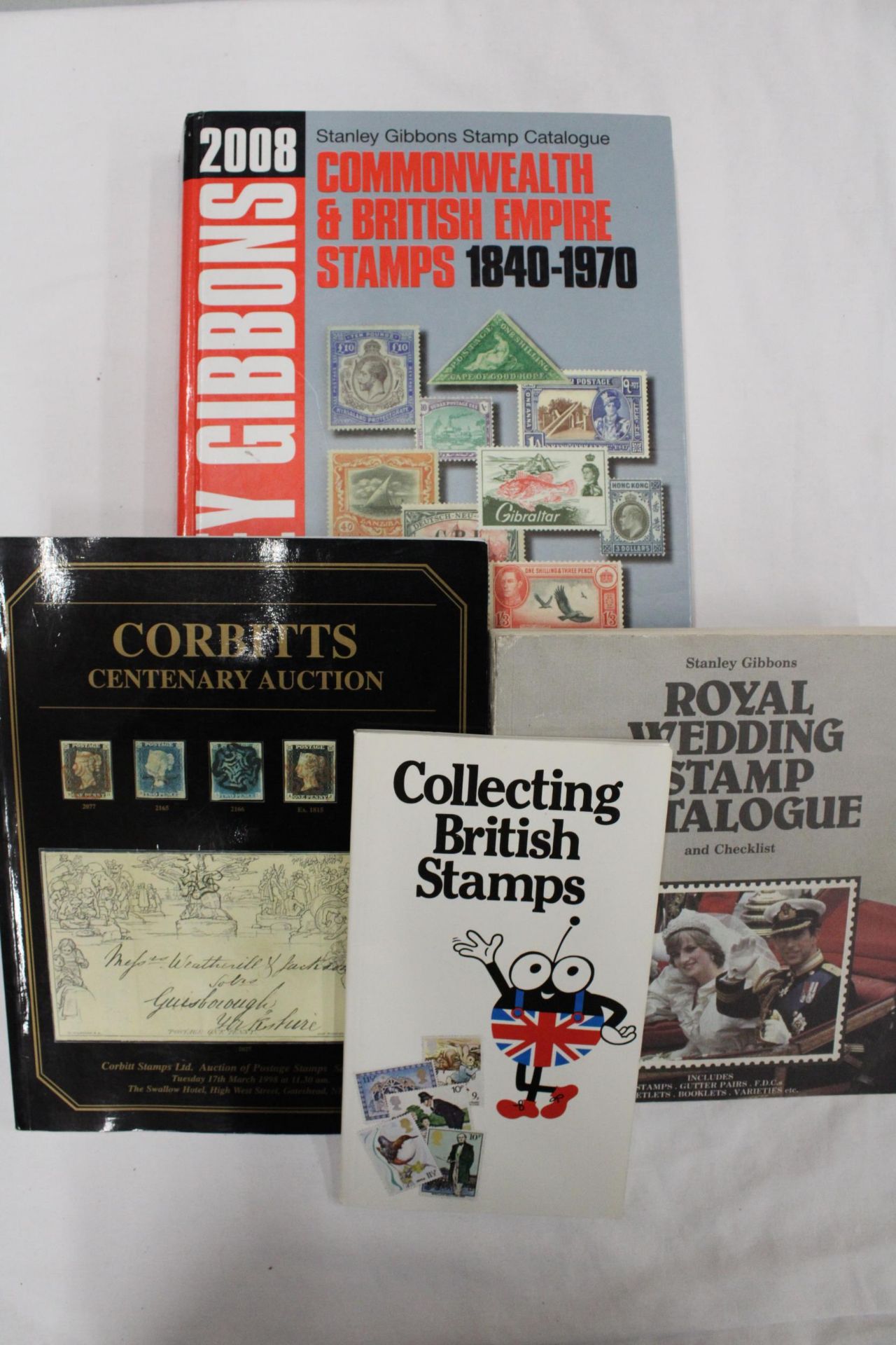 FOUR STAMP BOOKS TO INCLUDER COLLECTING BRITISH STAMPS, ROYAL WEDDING STAMP CATALOGUE, CORBITTS