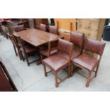 A MID 20TH CENTURY OAK REFECTORY TABLE, 57" X 30" AND NINE STUDDED DINING CHAIRS, ONE BEING A CARVER