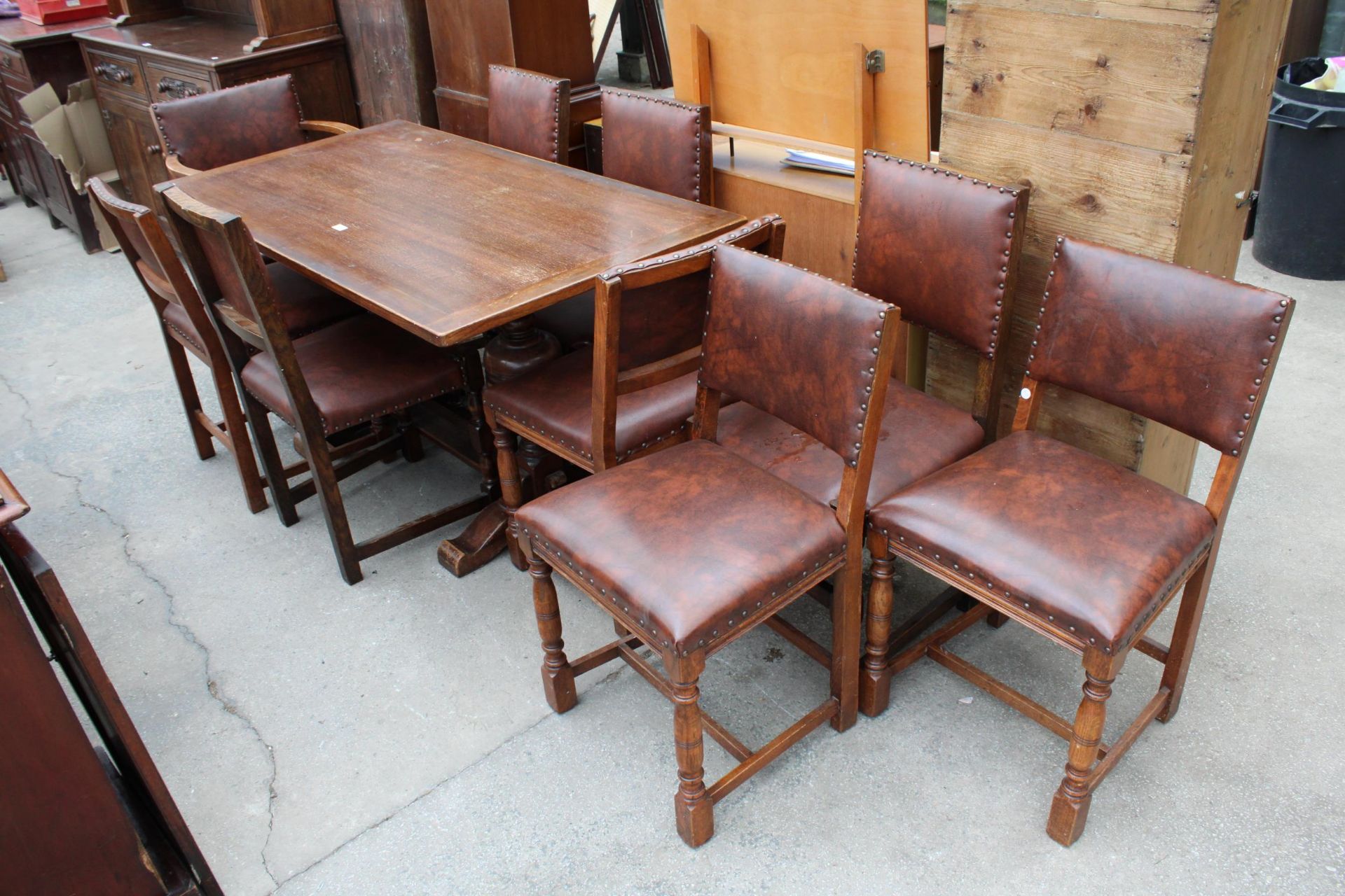 A MID 20TH CENTURY OAK REFECTORY TABLE, 57" X 30" AND NINE STUDDED DINING CHAIRS, ONE BEING A CARVER