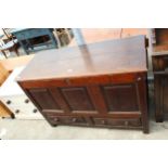 A GEORGE II OAK LANCASHIRE CHEST WITH TWO DRAWERS TO BASE AND A THREE PANEL FRONT 52" WIDE