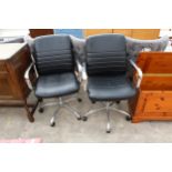 A PAIR OF COSTCO SWIVEL DESK CHAIRS WITH POLISHED CHROME ARMS AND BASES