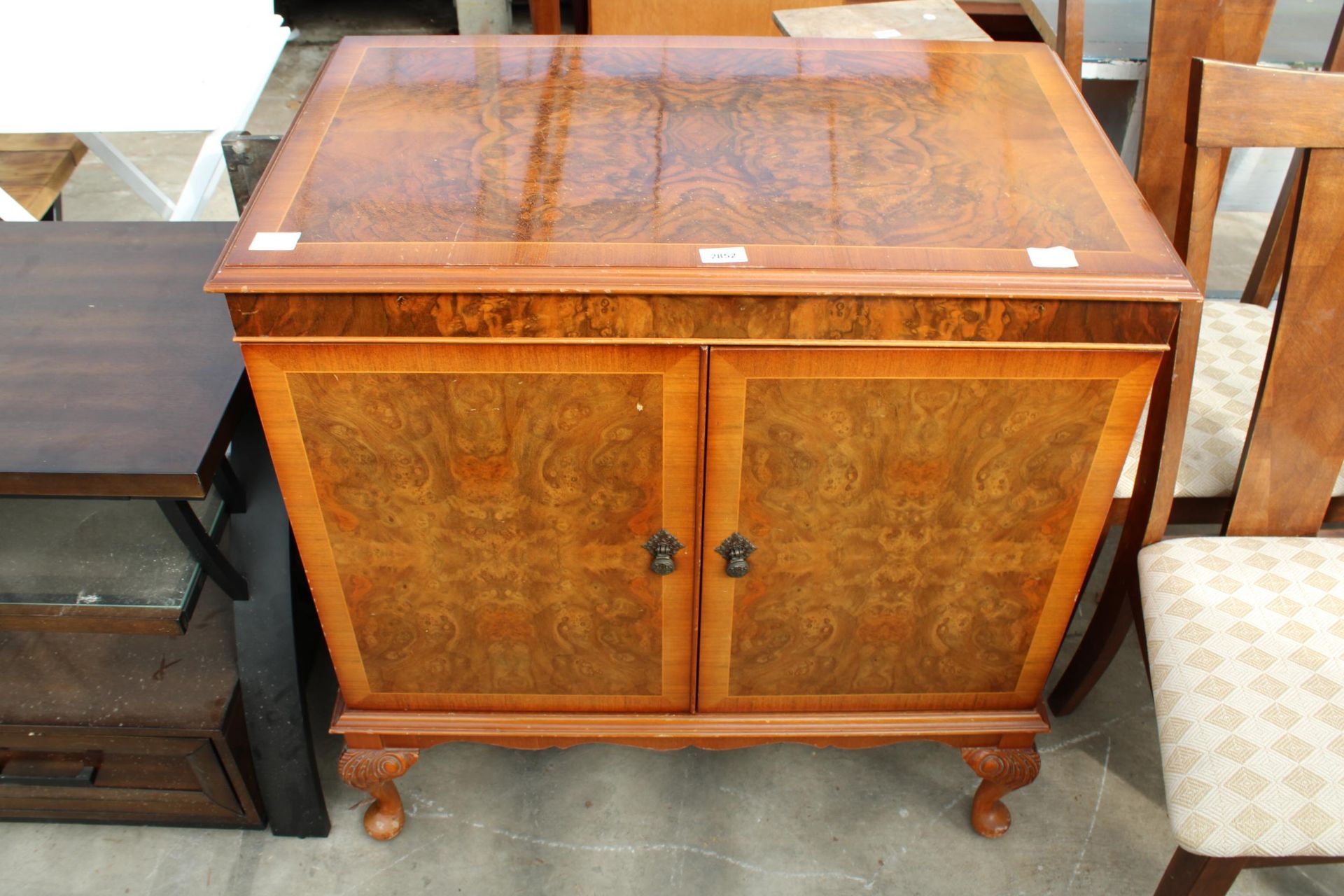 A CHARLES SHERATON WALNUT AND CROSSBANDED CABINET ON CABRIOLE LEGS, 33" WIDE