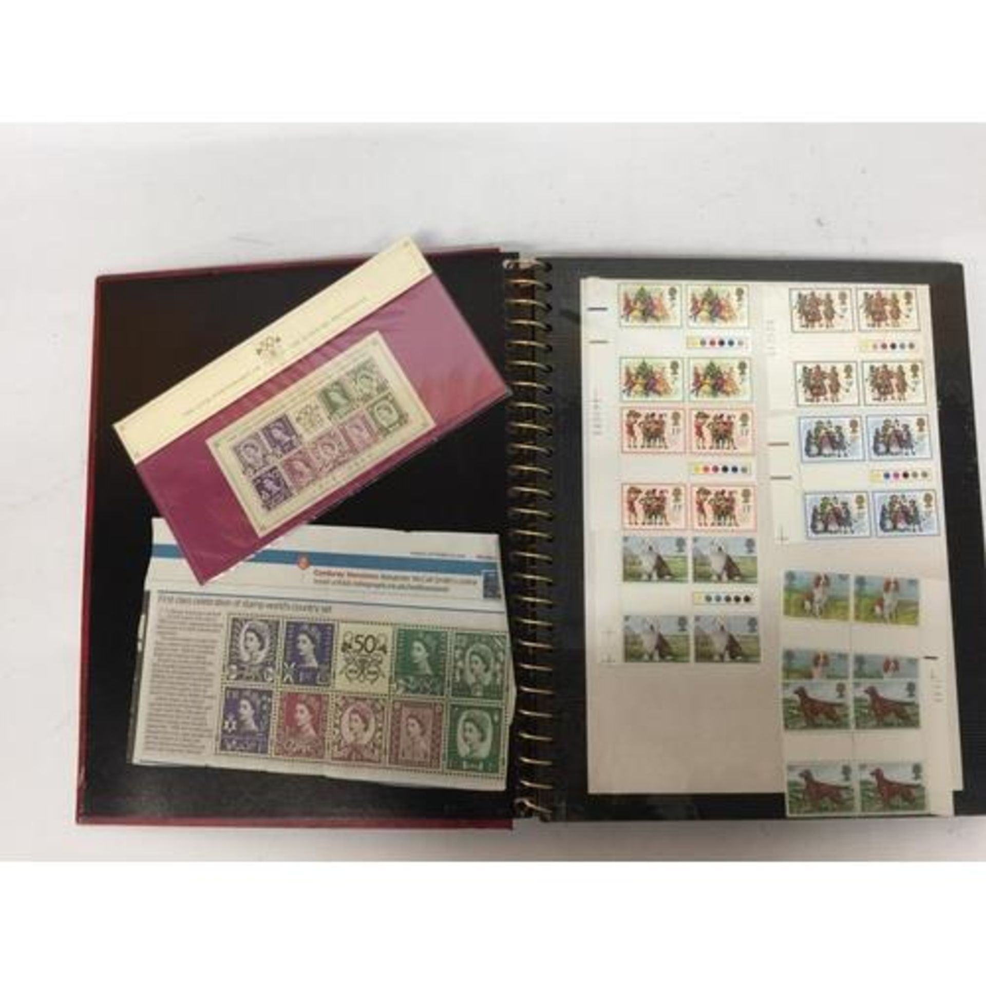 A STAMP ALBUM CONTAINING A LARGE QUANTITY OF BRITISH MINT STAMPS
