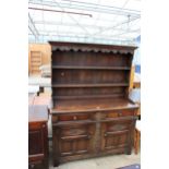 AN OAK JACOBEAN STYLE DRESSER WITH CARVED PANELS AND PLATE RACK, 56" WIDE
