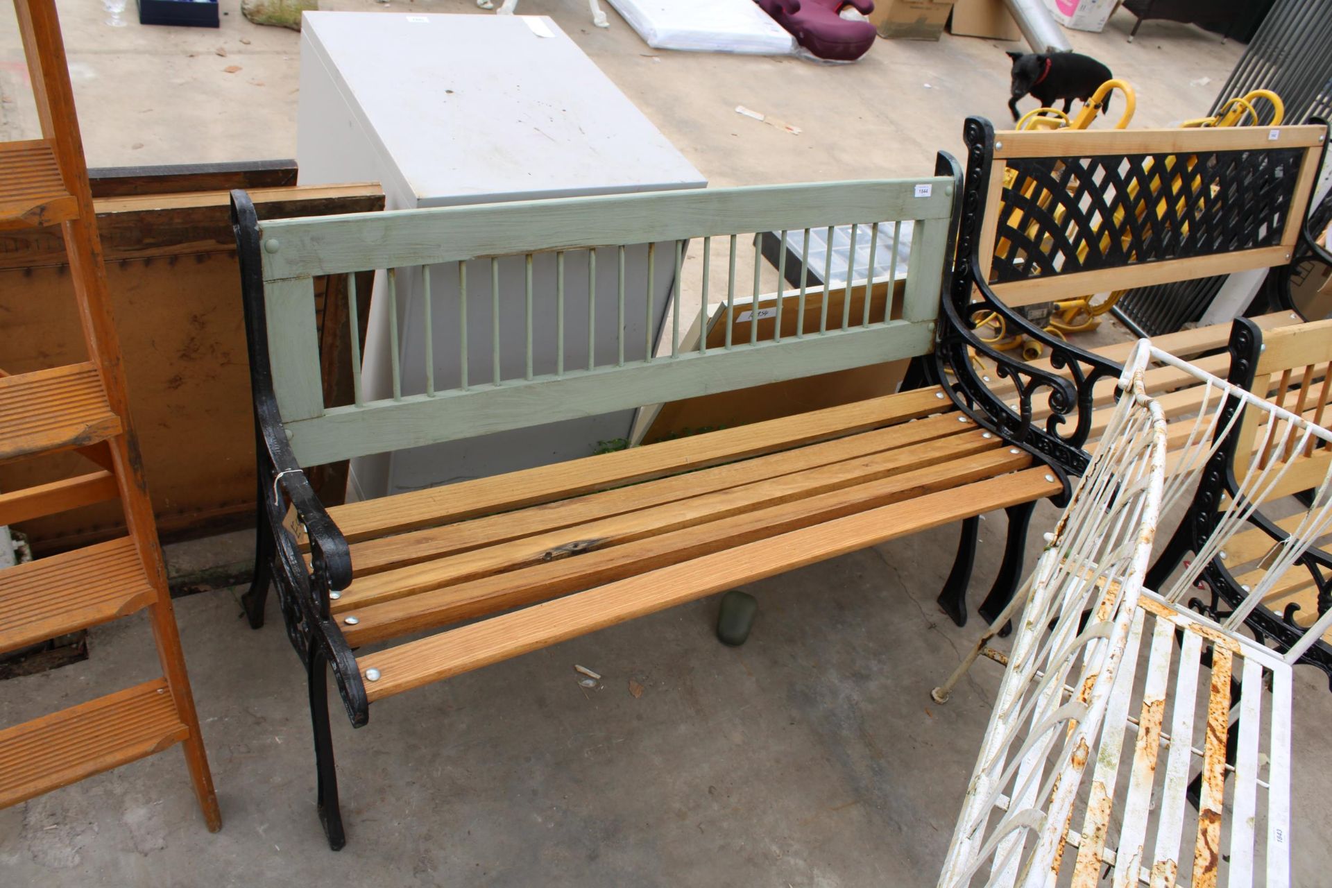 A WOODEN SLATTED GARDEN BENCH WITH DECORATIVE CAST BENCH ENDS - Image 2 of 2