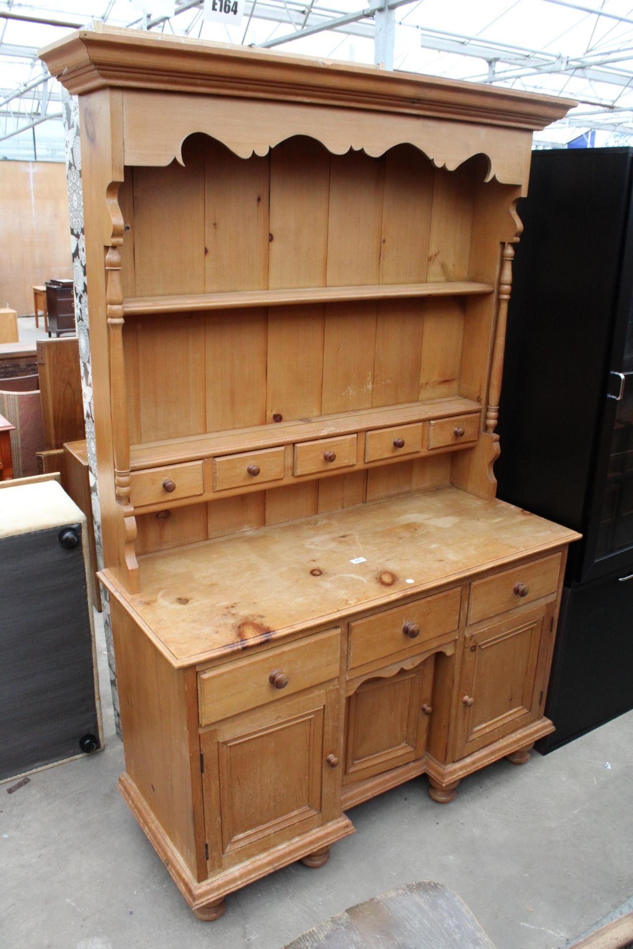 A MODERN PINE KITCHEN DRESSER WITH THREE CUPBOARDS AND THREE DRAWERS TO BASE COMPLETE WITH PLATE