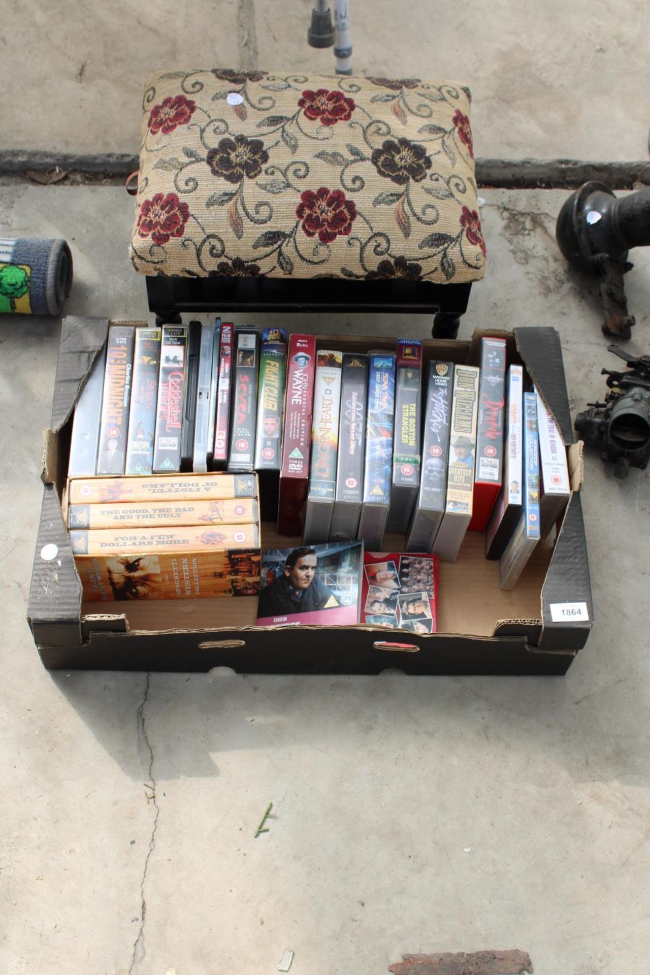 AN ASSORTMENT OF VHS AND DVDS AND A FOOT STOOL