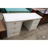 A MODERN WHITE TWIN-PEDESTAL DRESSING TABLE