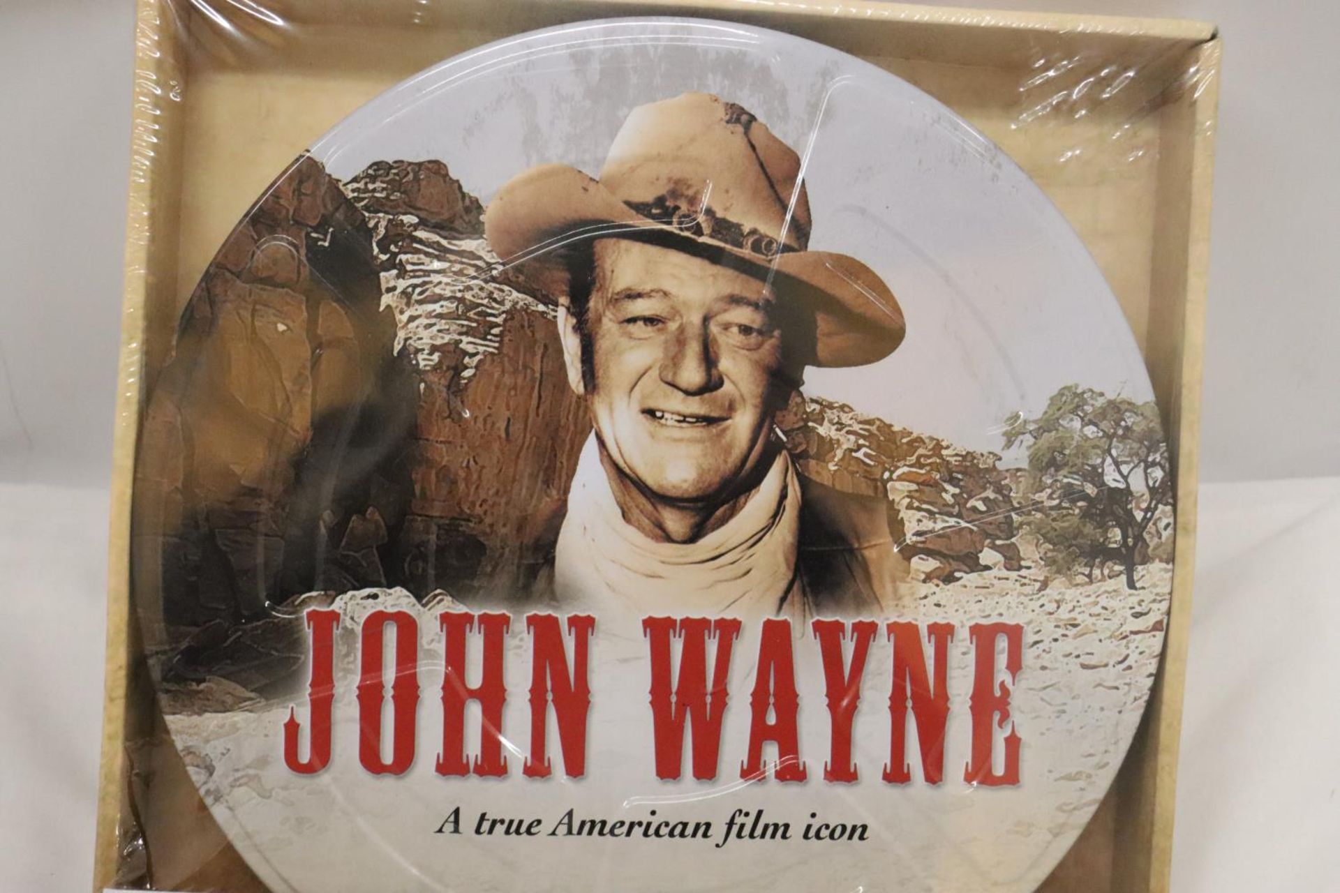 A NEW AND SEALED SET OF FIVE JOHN WAYNE DVD'S IN A METAL GIFT TIN