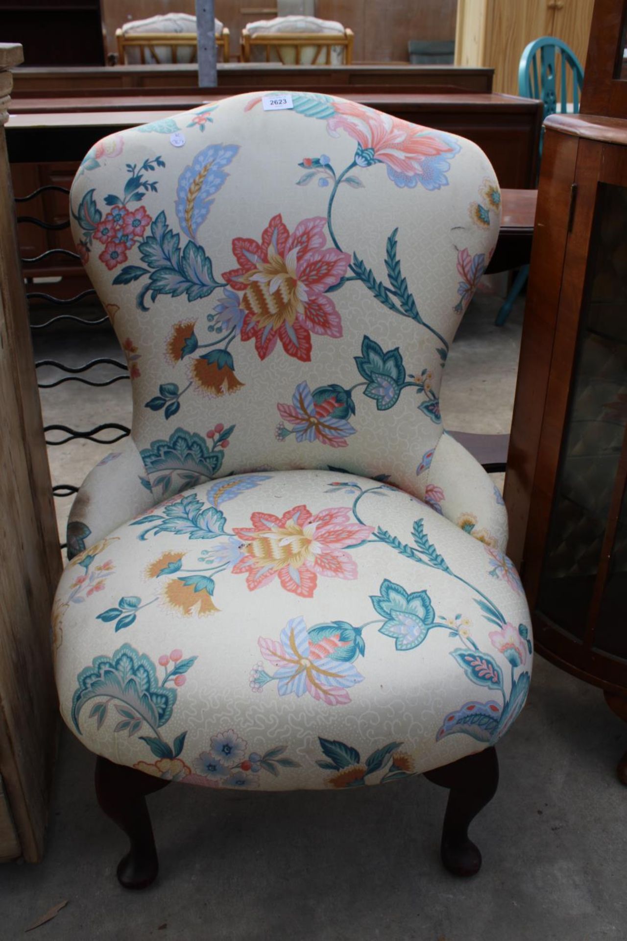 A MODERN FLORAL BEDROOM CHAIR ON FRONT CABRIOLE LEGS