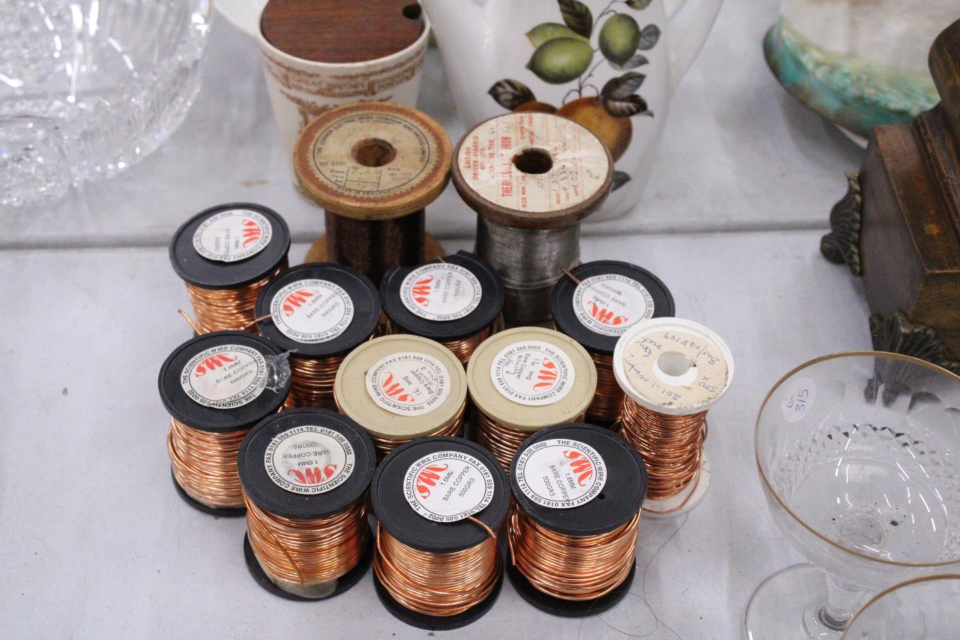 TWELVE SPOOLS OF COPPER WIRE AND ONE SPOOL OF IRON WIRE