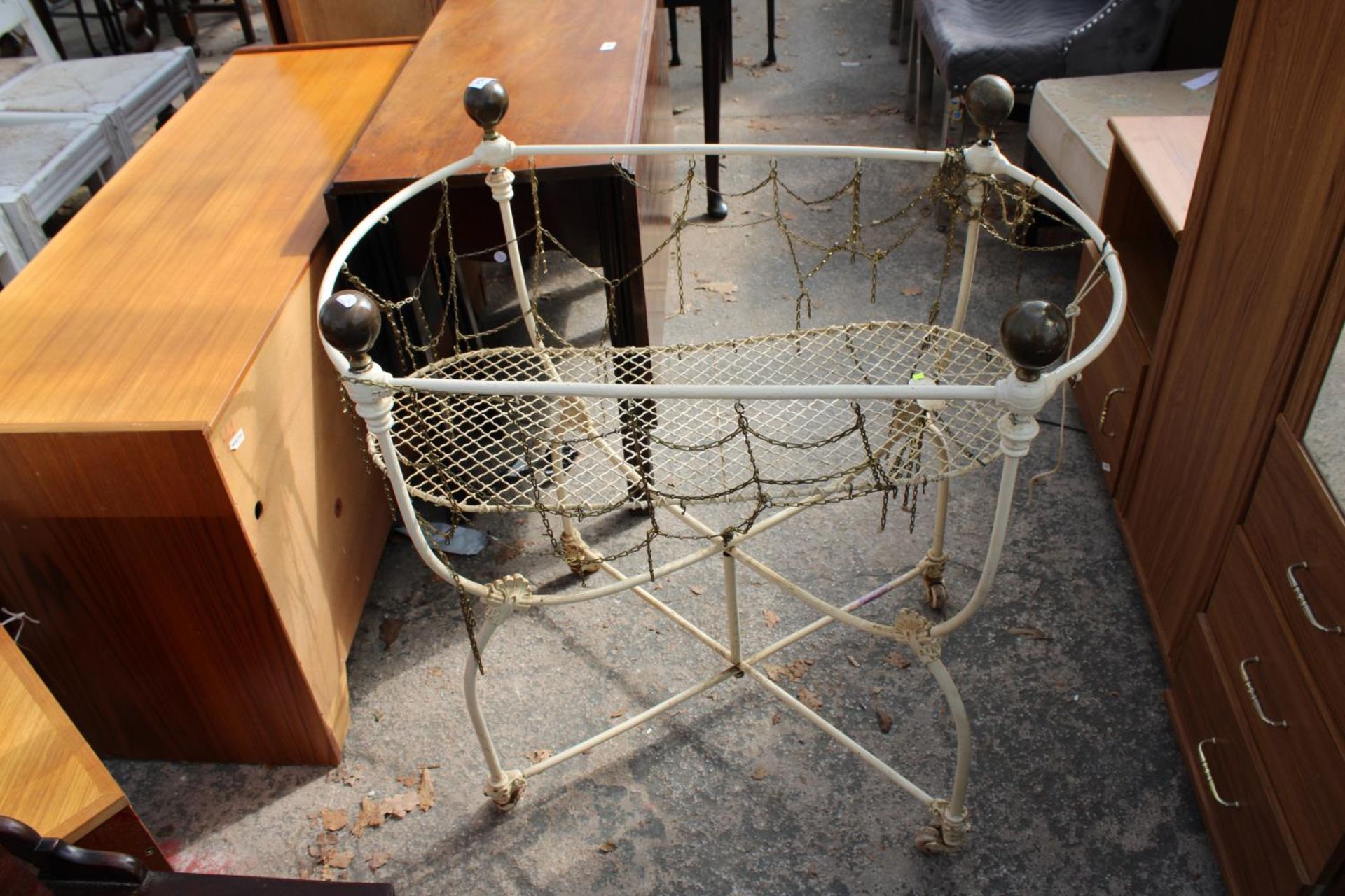 A VICTORIAN CAST IRON FOLDING COT WITH BRASS KNOBS BEARING HOSKINS PATENT COT LABEL