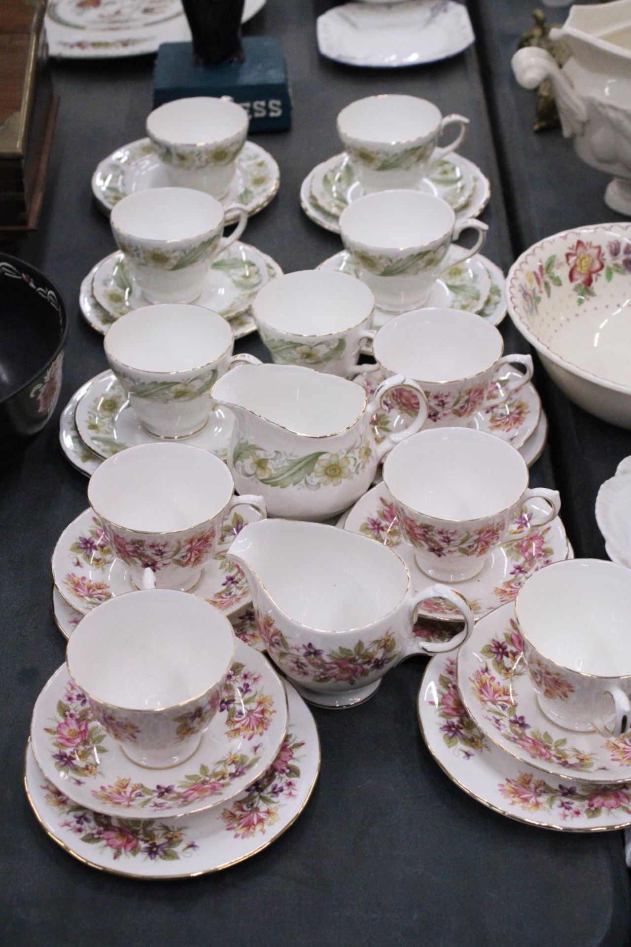 A QUANTITY OF CHINA CUPS, SAUCERS, SIDE PLATES AND CREAM JUGS BY COLCLOUGH AND DUCHESS