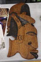 A PAIR OF LARGE CARVED WOODEN HEADS, IN THE STYLE OF PICASSO, 48CM X 26CM