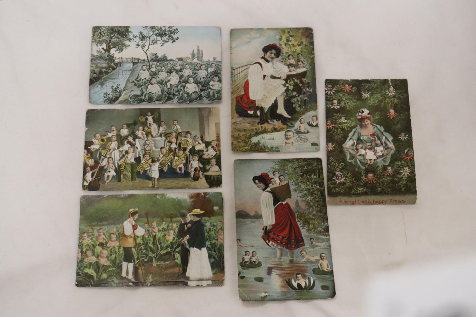 SEVEN EARLY 1900'S POSTCARDS TO INCLUDE FRENCH CABBAGE BABIES, ETC