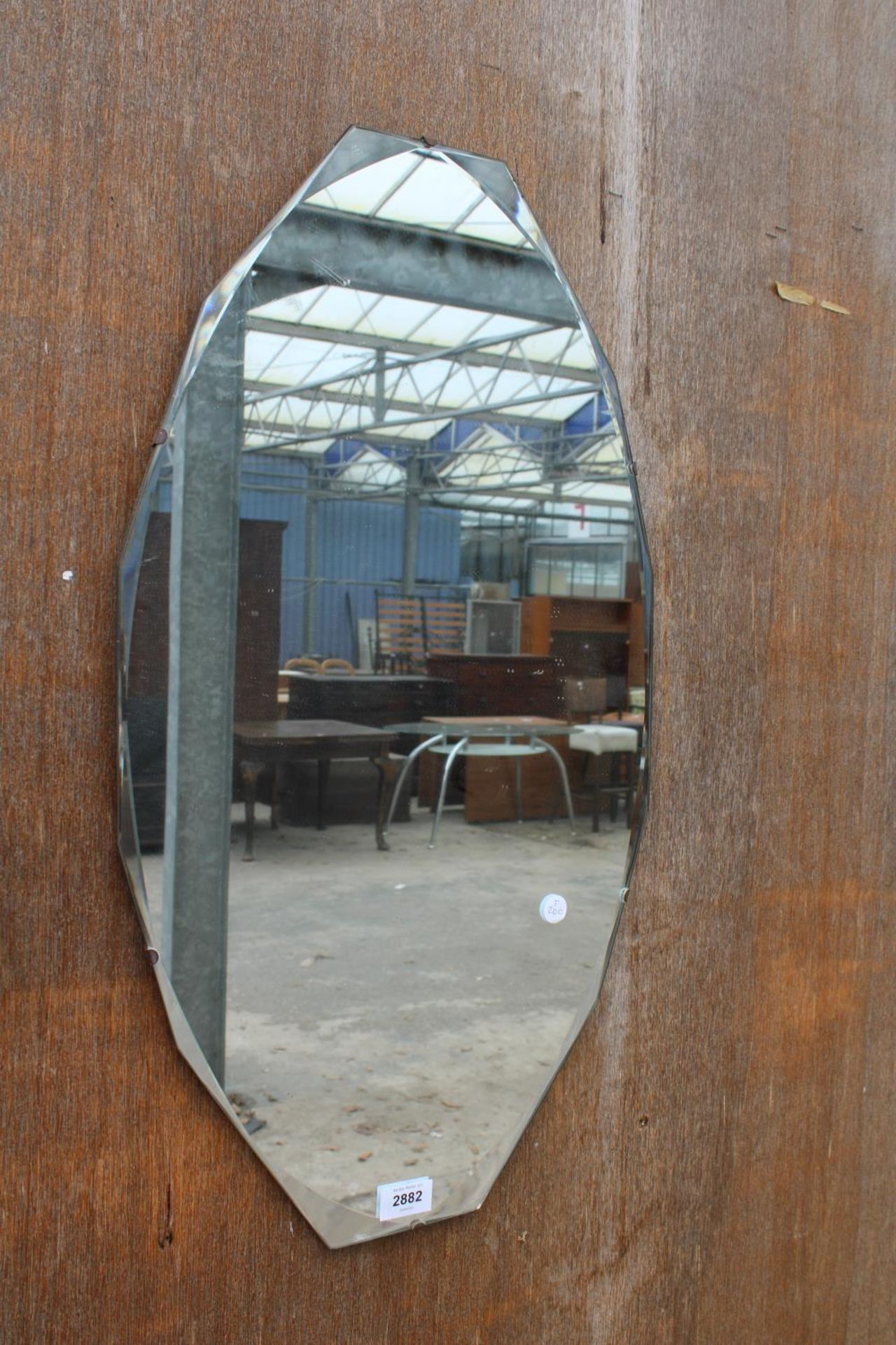 A MID 20TH CENTURY FRAMELESS WALL MIRROR 27" X 15"