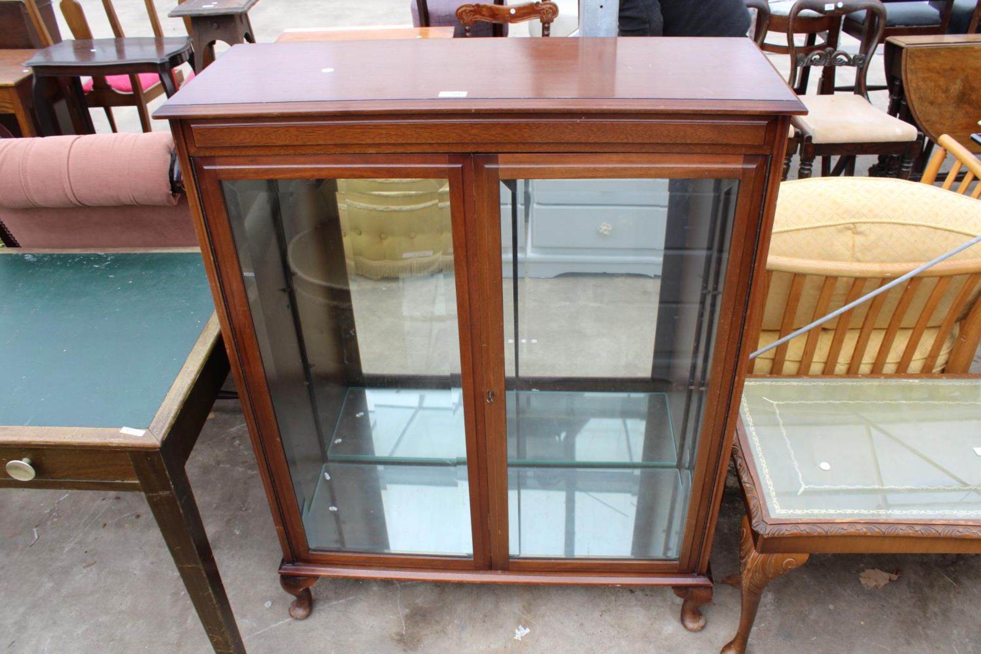 A MODERN MAHOGANY DISPLAY CABINET WITH BEVELLED GLASS DOORS ON CABRIOLE LEGS, 36" WIDE
