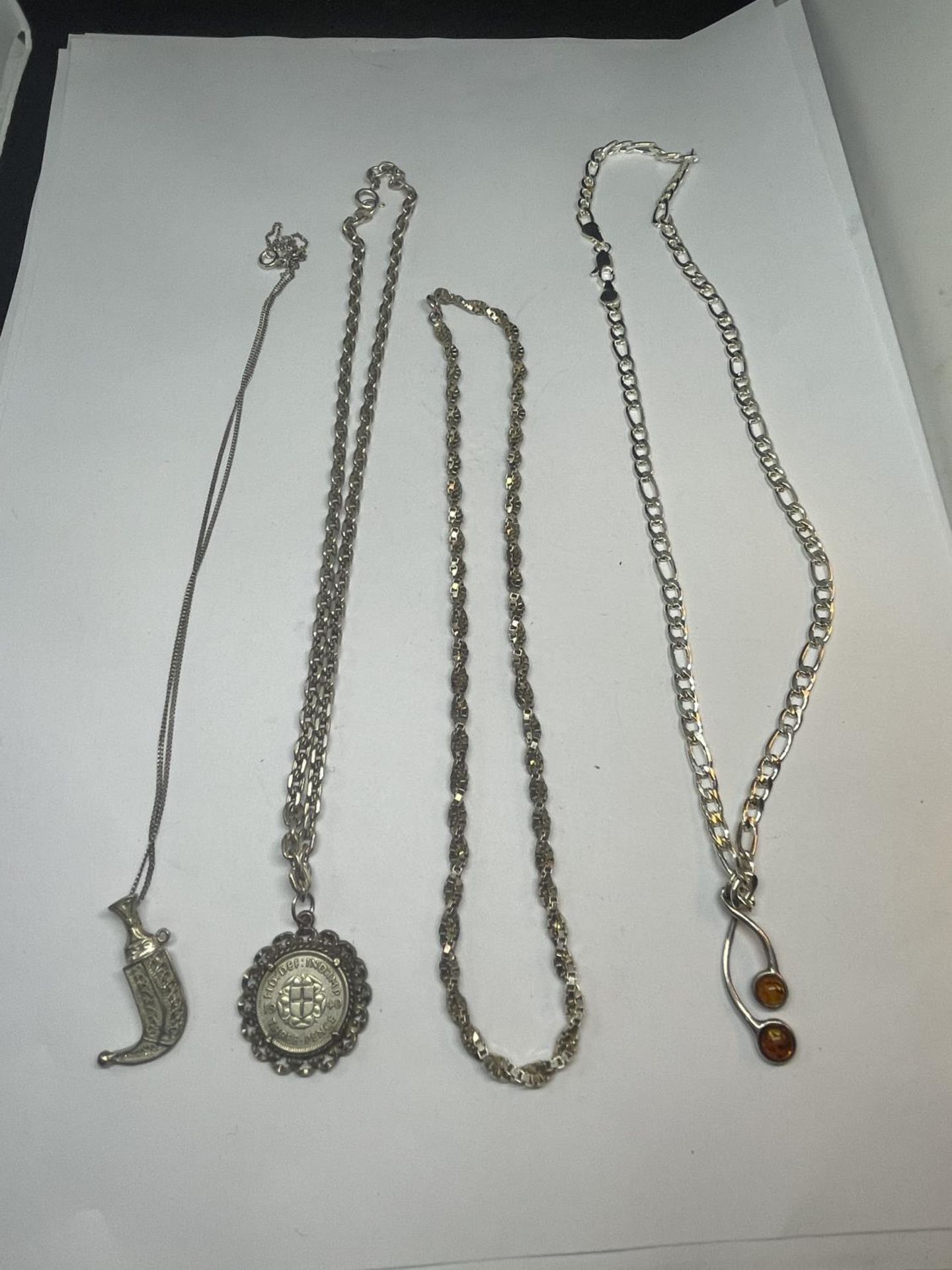 FOUR SILVER NECKLACES WITH PENDANTS