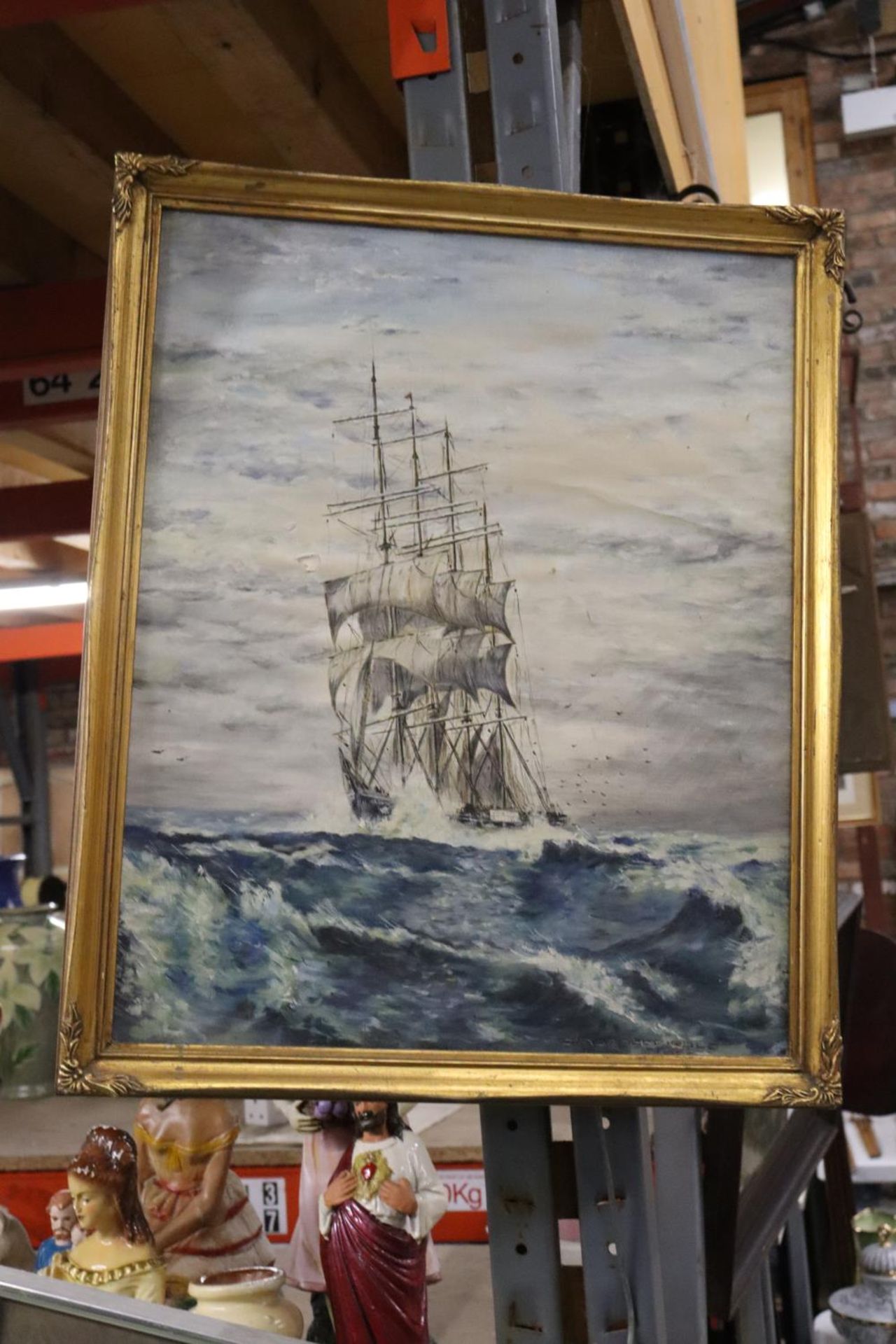 A SIGNED FRAMED OIL ON CANVAS OF A SAILING SHIP ON STORMY SEAS