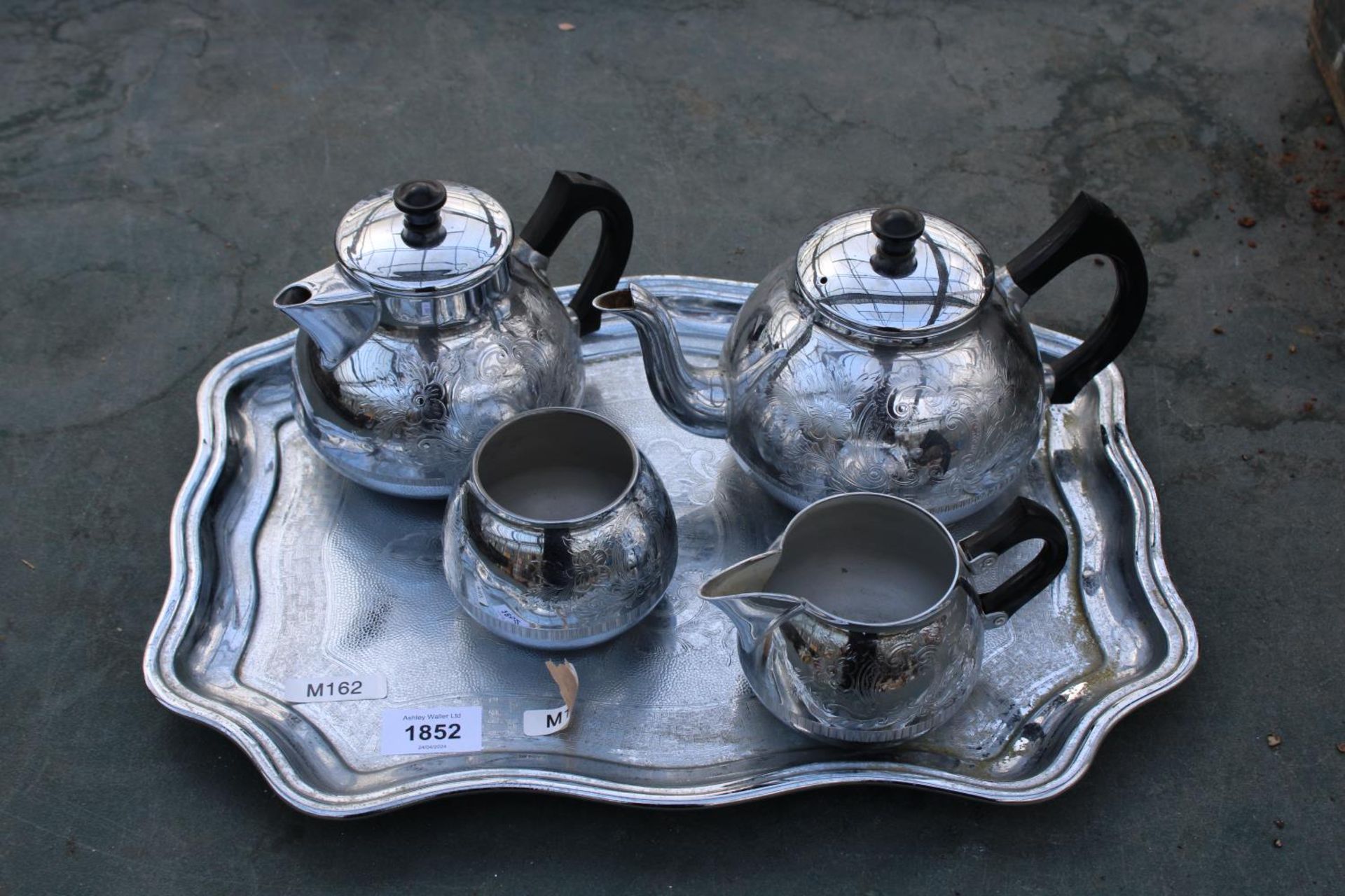 A METALWARE TRAY AND A TEA SERVICE COMPRISING OF TWO TEAPOTS, SUGAR BOWL AND JUG