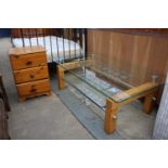 A MODERN PINE BEDSIDE CHEST AND TWO TIER GLASS COFFEE TABLE