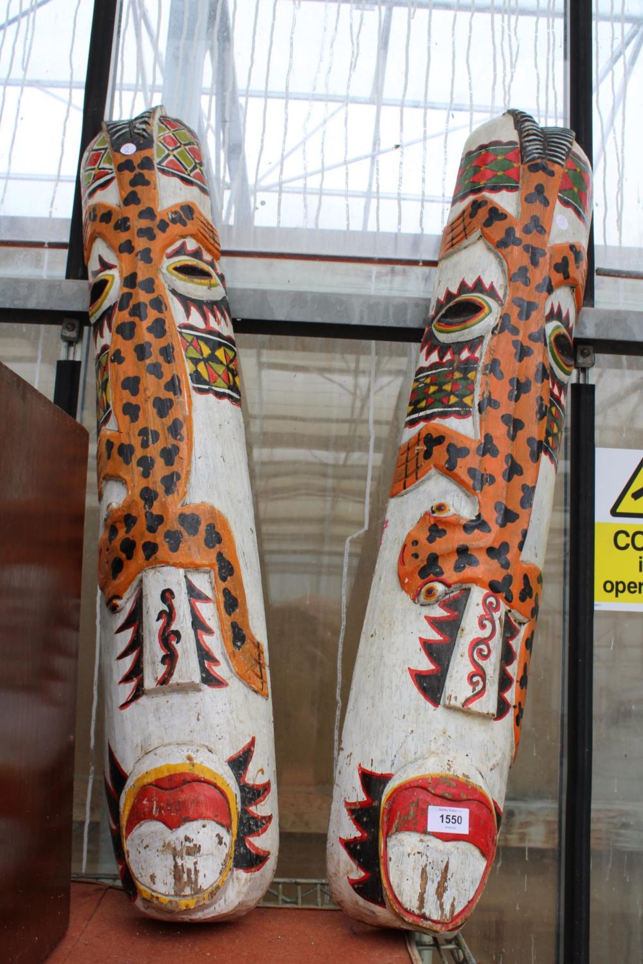 A PAIR OF WOODEN PAINTED TOTEM MASKS