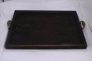 A WOODEN SERVING TRAY WITH METAL HANDLES MARKED - ST DUNSTANS