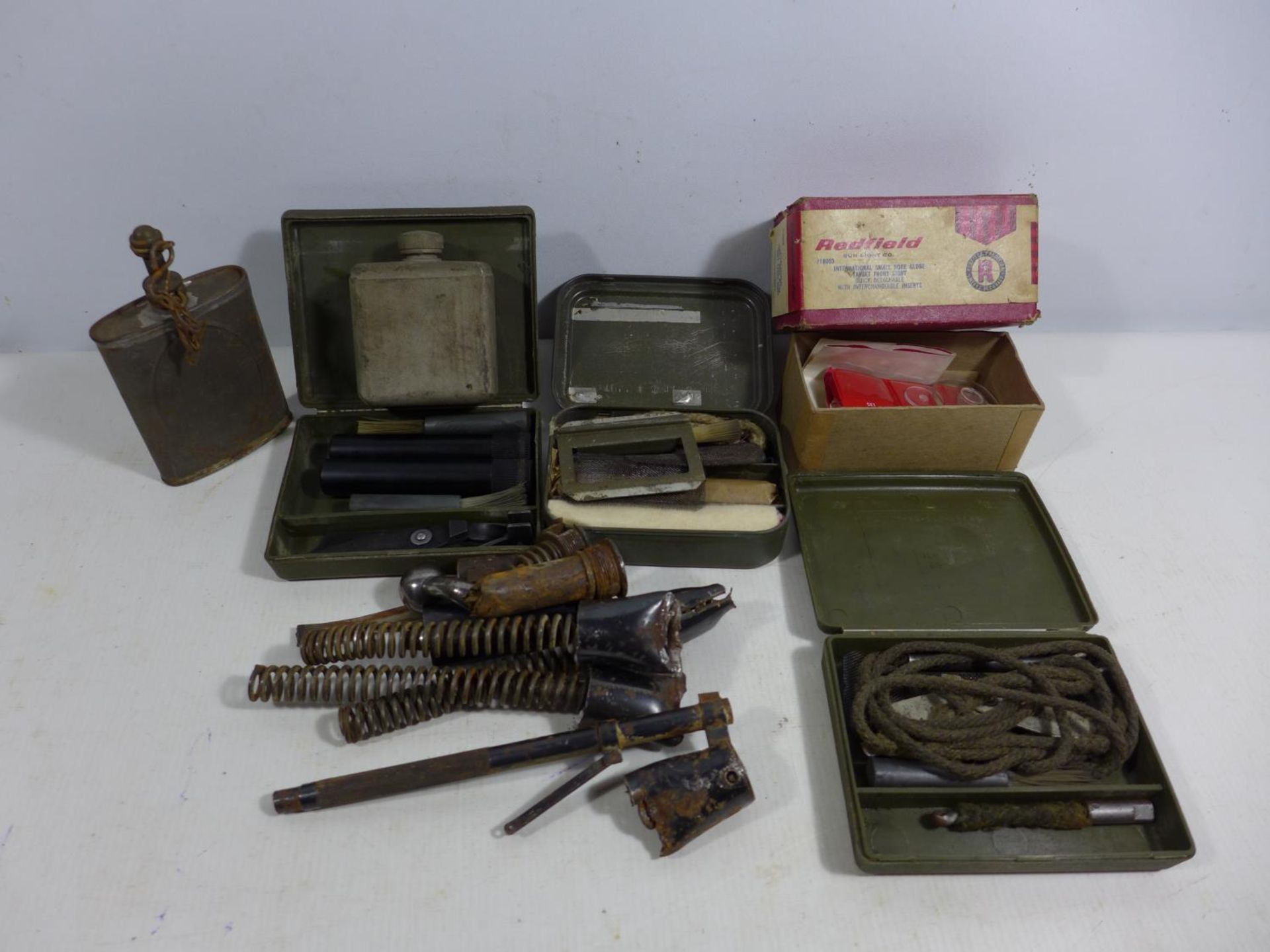 A COLLECTION OF GUN CLEANING EQUIPMENT, AIR RIFLE SPRINGS, OIL BOTTLES ETC