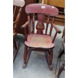 A VICTORIAN STYLE ELM AND BEECH CHILDS ROCKING CHAIR