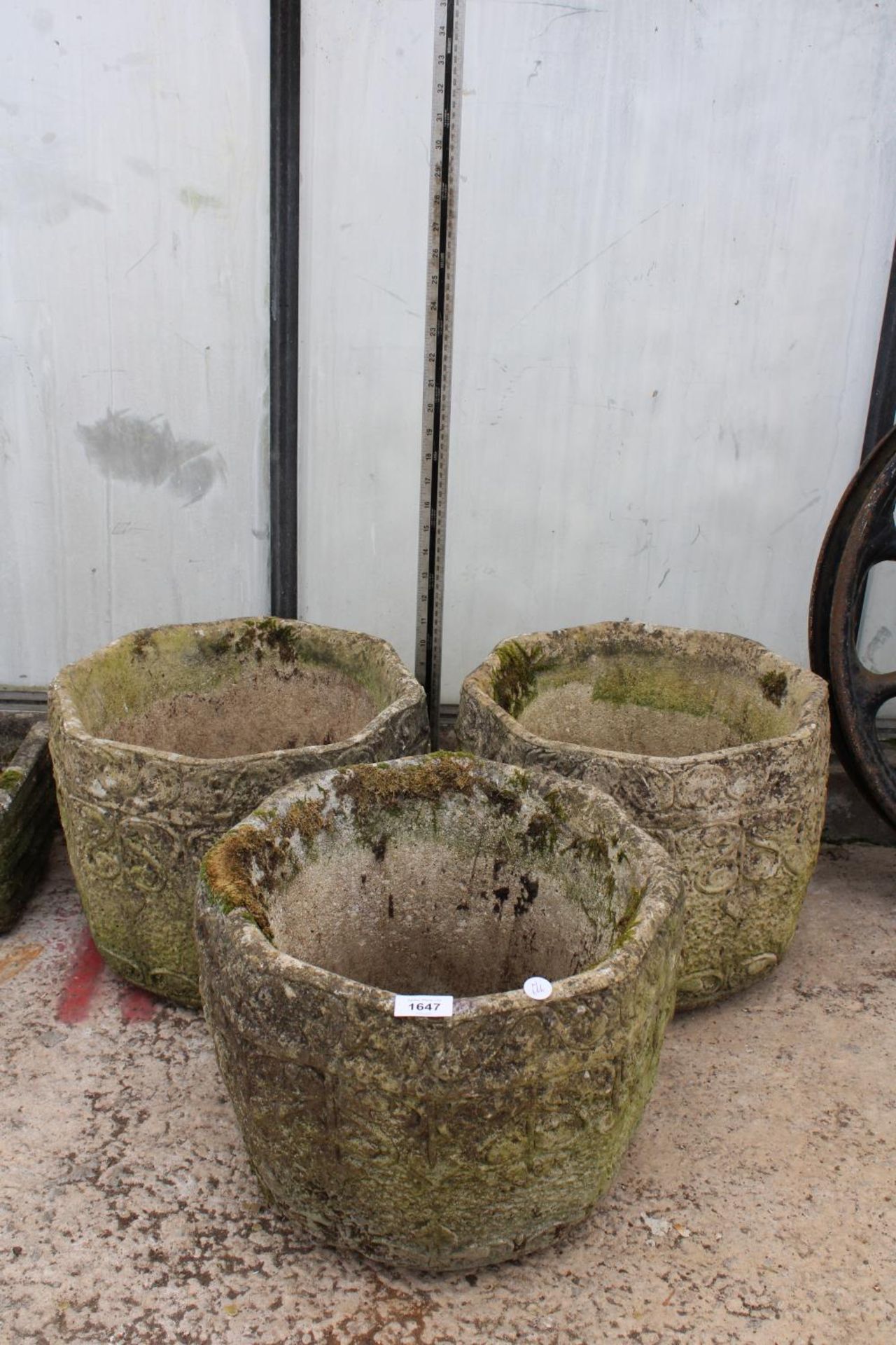 A SET OF THREE MATCHING RECONSTITUTED STONE GARDEN POTS