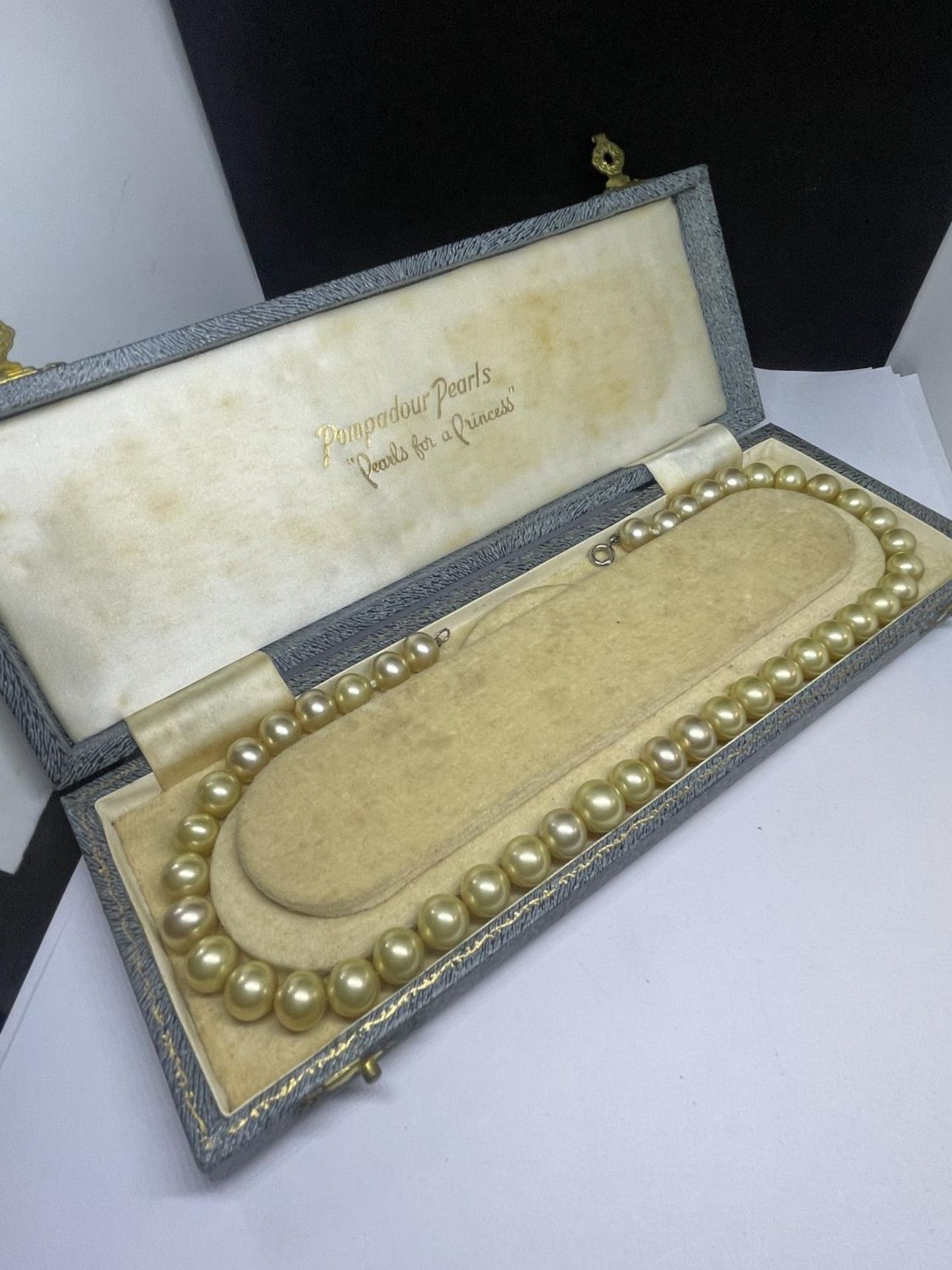 A PEARL NECKLACE IN A PRESENTATION BOX