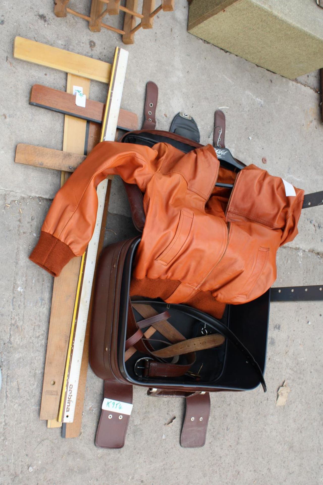 A SUITCASE, A JACKET AND MEASURING SQUARES ETC