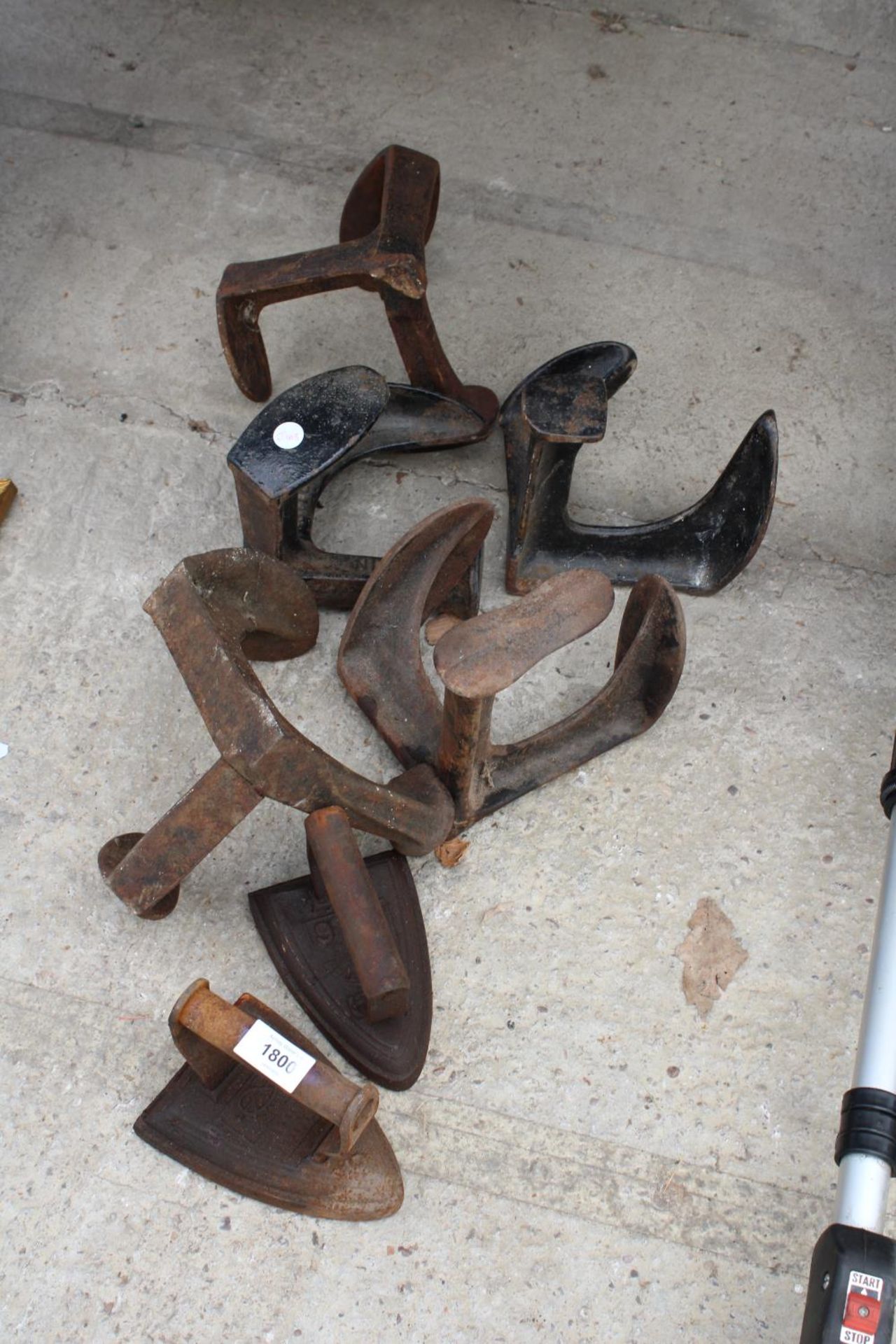 AN ASSORTMENT OF VINTAGE COBBLERS LASTS AND FLAT IRONS