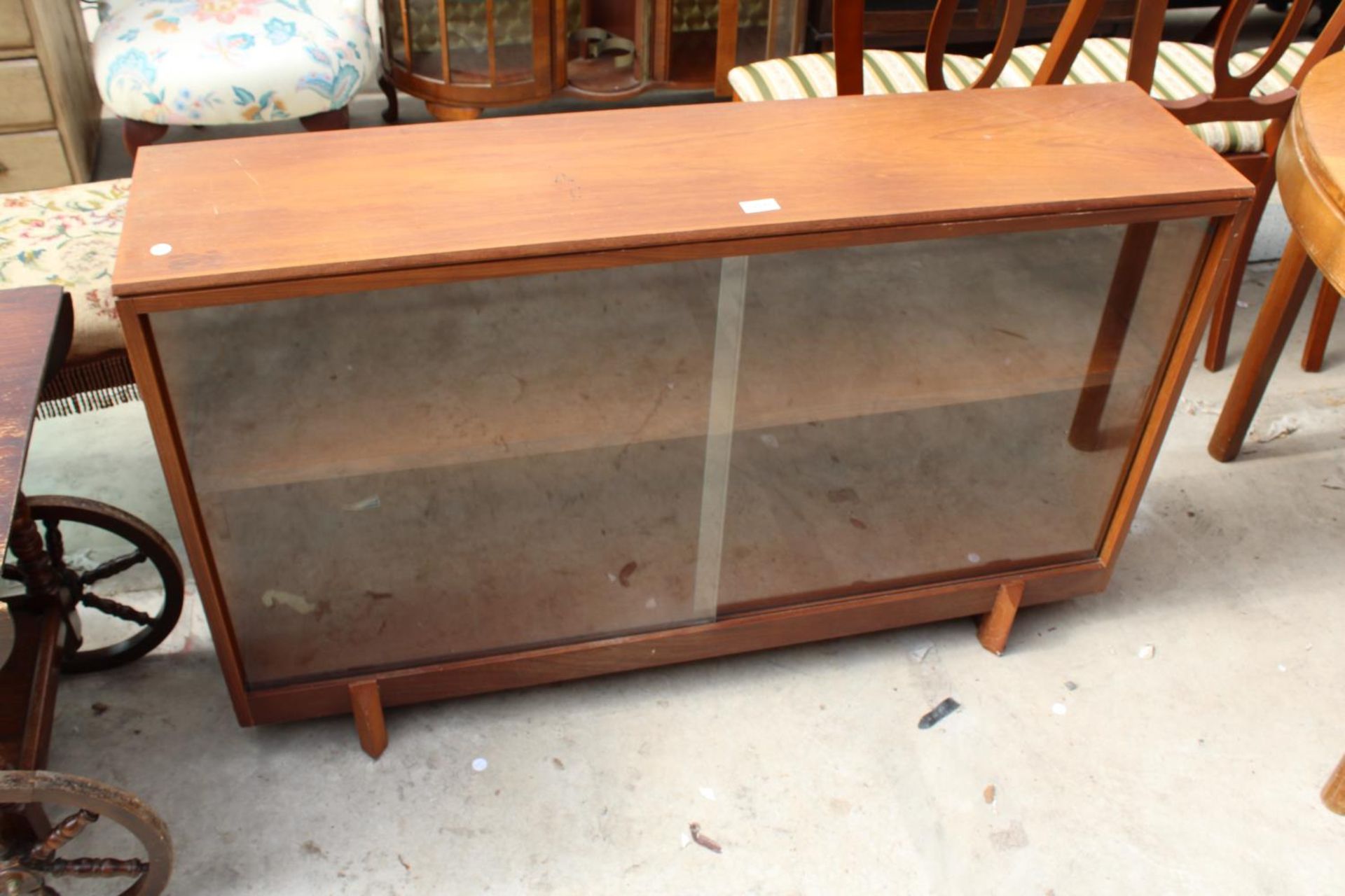 A RETRO TEAK BOOKCASE WITH 2 GLASS SLIDING DOORS, 48" WIDE