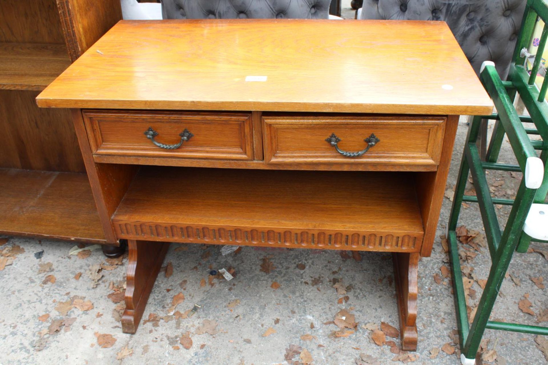 A SMALL OAK LOW SIDE-TABLE ENCLOSING 2 DRAWERS, 32" WIDE